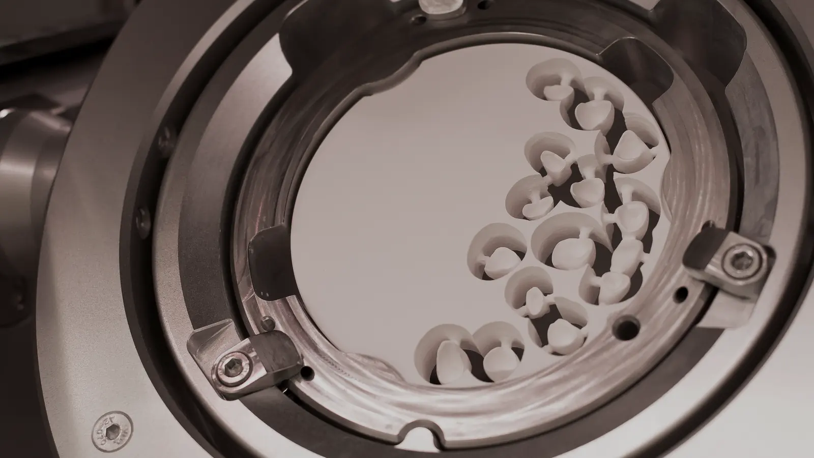 A dental milling machine cutting restorations from a zirconia disc